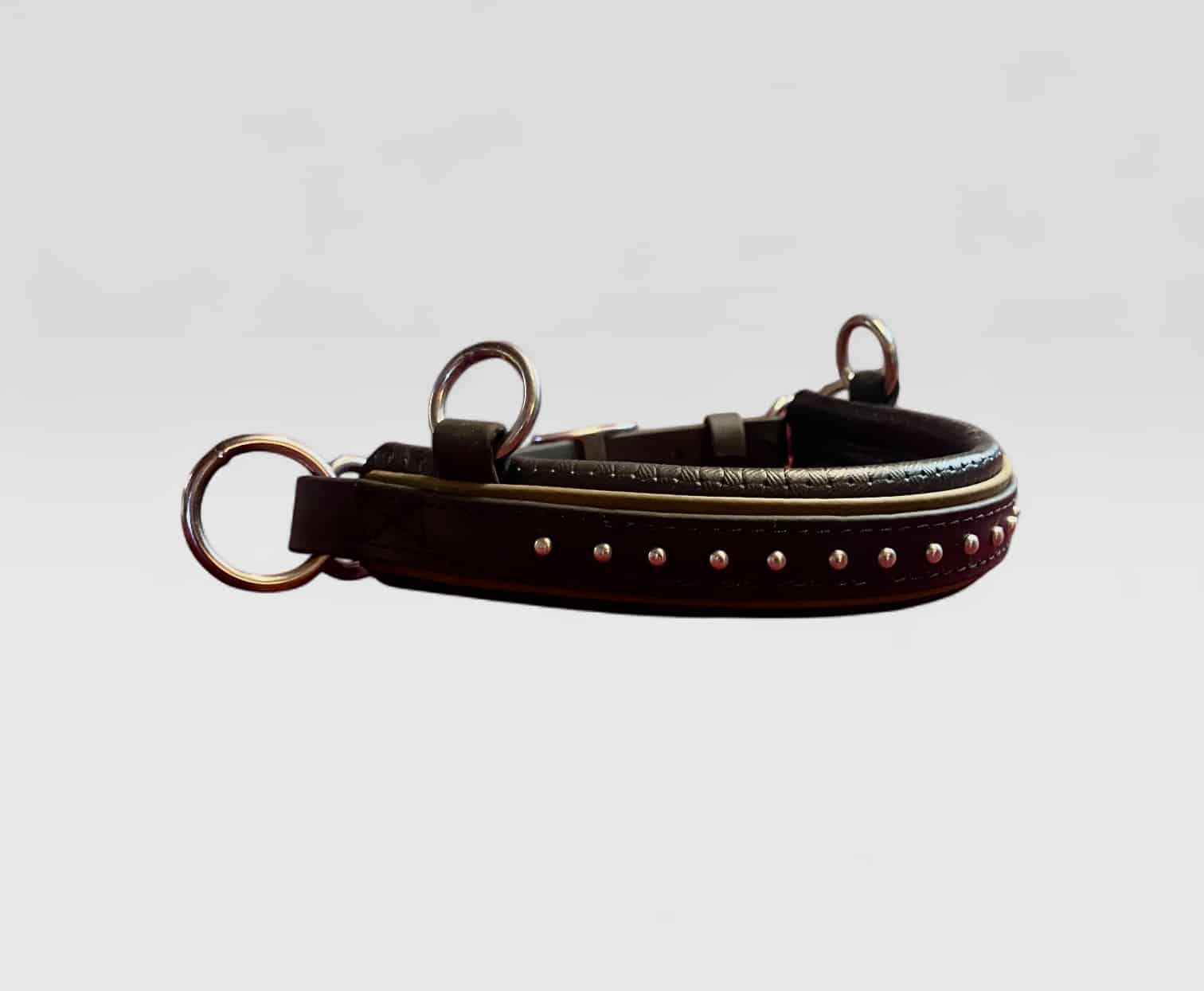 SpottedSPAttach | Madtack Black leather dog collar with metal studs and two buckle rings lying on its side.